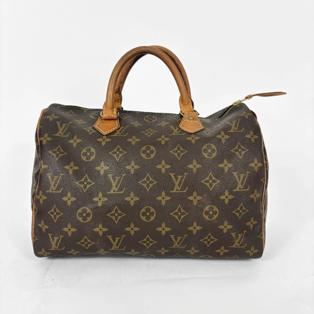 Brown handbag with monogram pattern on a white background