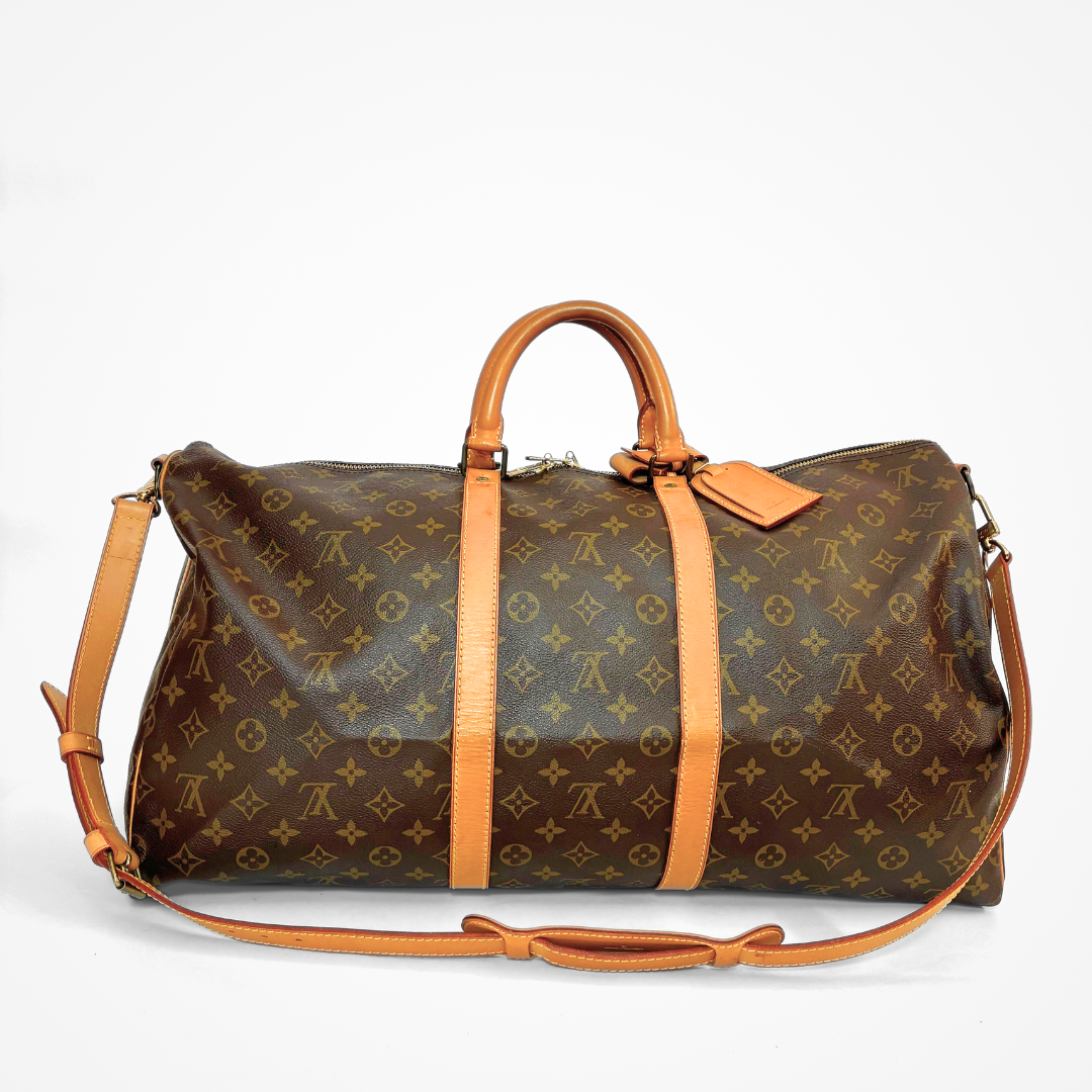Brown LV duffel bag with monogram canvas and tan leather straps on a white background