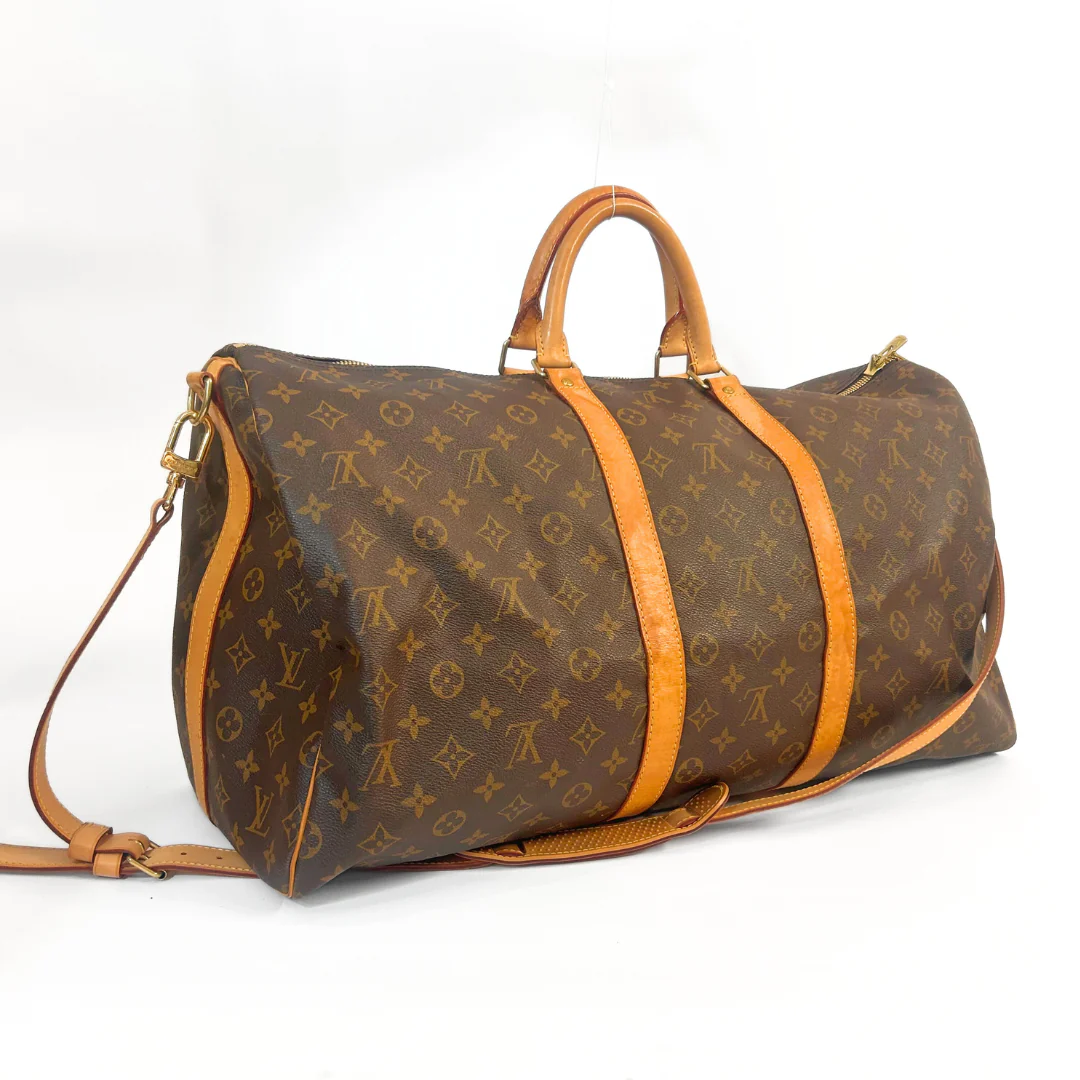 Brown duffel bag with orange straps on a white background