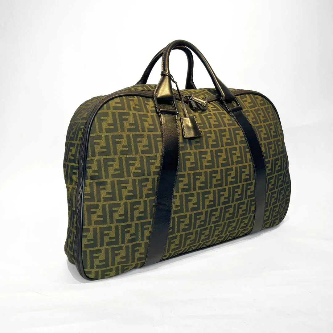 Green and black patterned travel bag on a white background