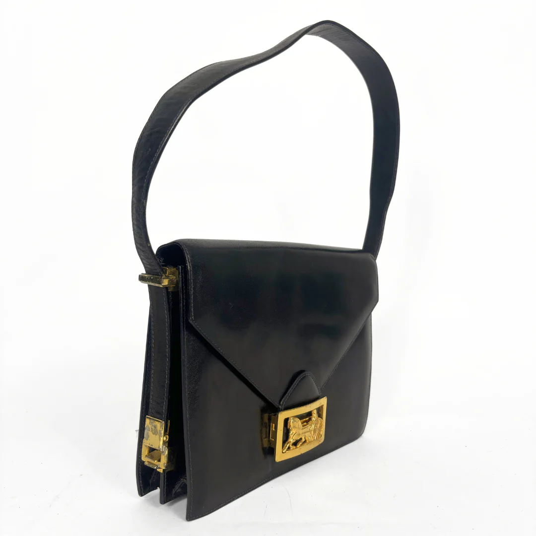 Celine vintage black leather shoulder bag with gold-tone horse and cariage buckle.