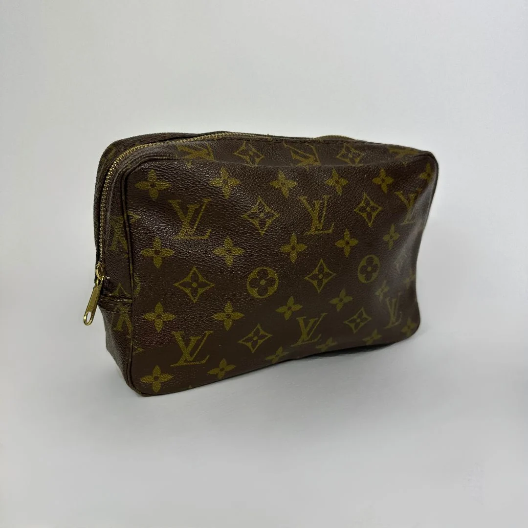 Louis Vuitton toiletry bag in front of white background