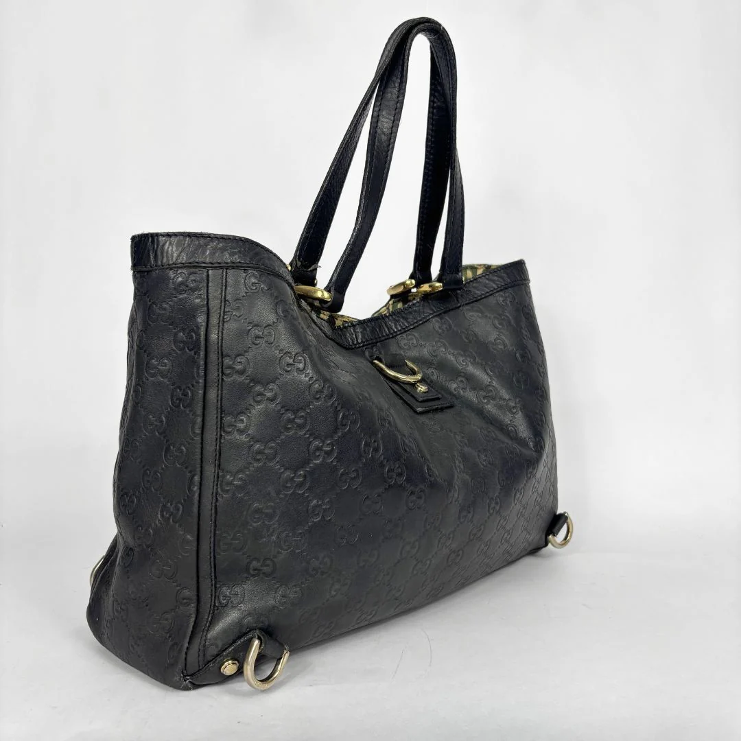 Black Gucci handbag on a white background
