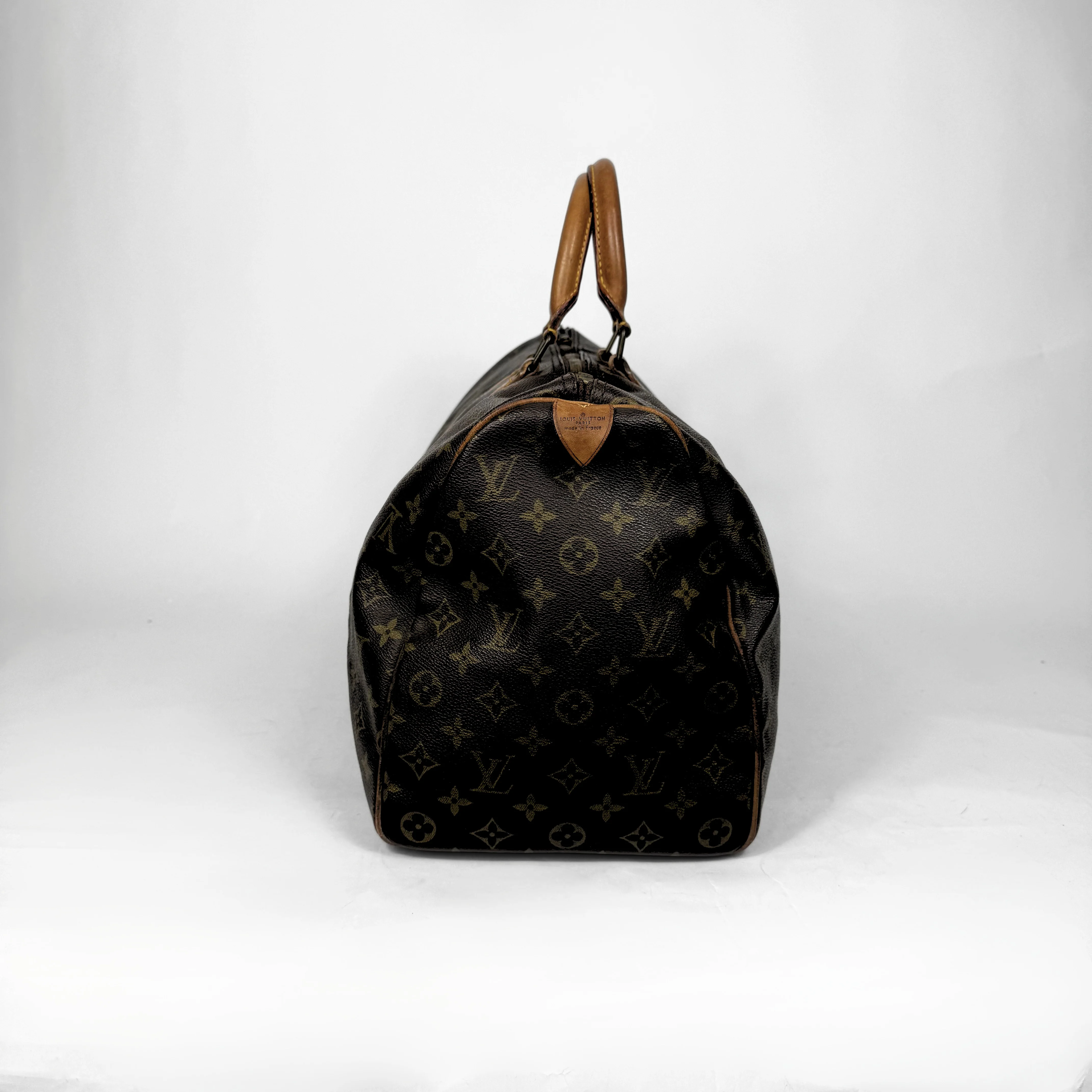 Designer handbag with monogram pattern on a white background