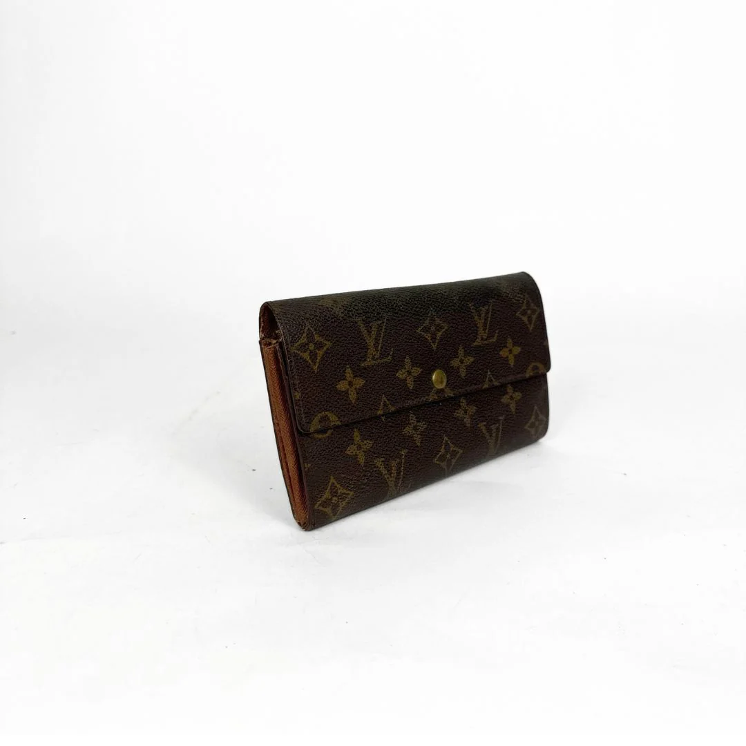 Brown wallet with monogram pattern on a white background