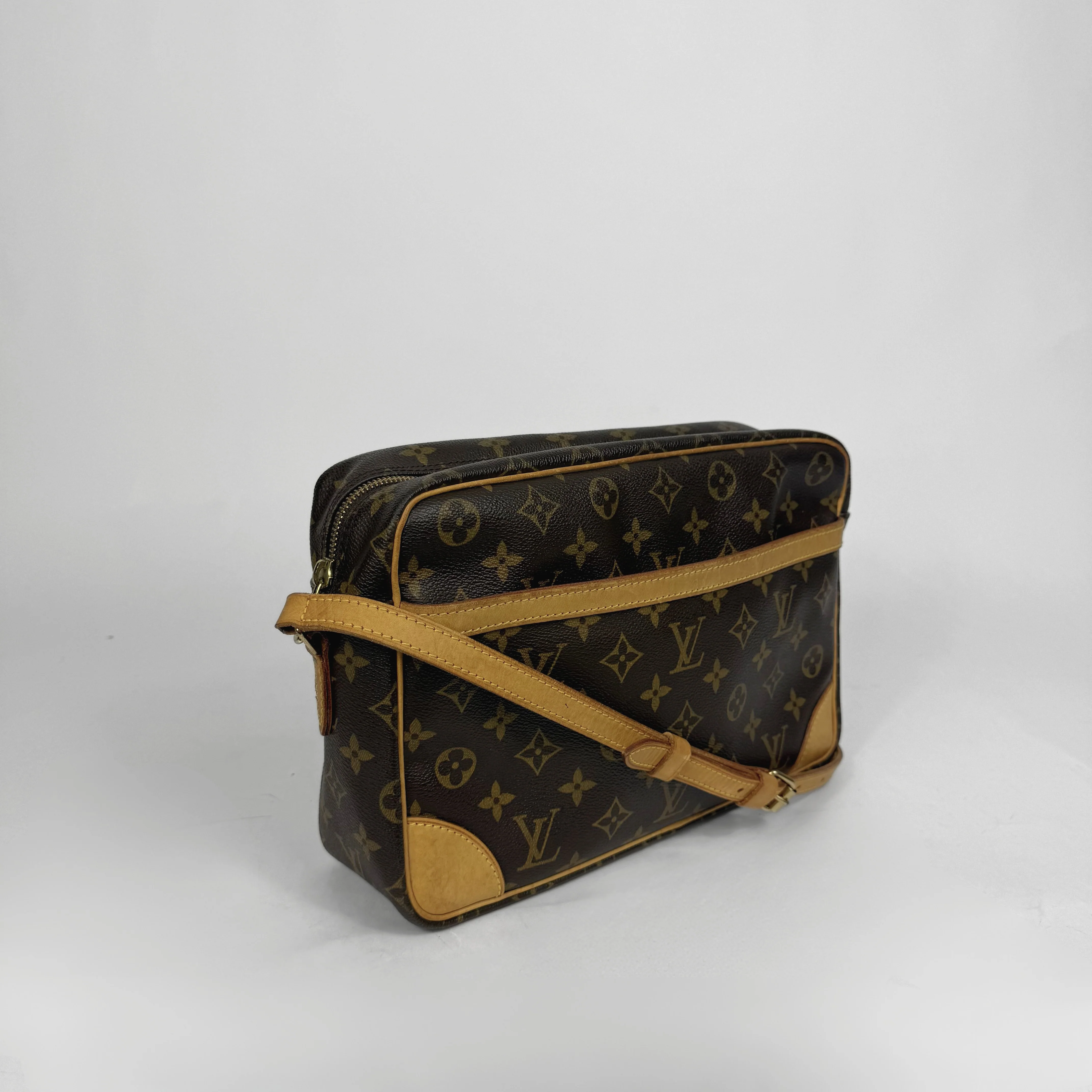 Designer handbag with monogram pattern on a white background