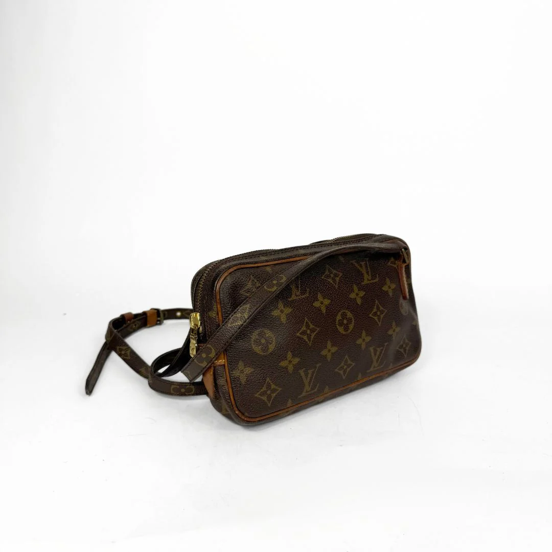 Brown leather bag with monogram pattern on a white background