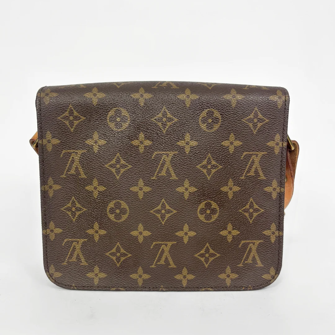 Louis Vuitton monogram handbag on a light gray background