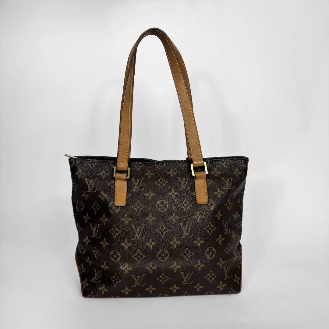 Louis Vuitton monogram canvas tote bag with tan leather shoulder straps and gold-tone hardware, photographed against a plain light gray background.