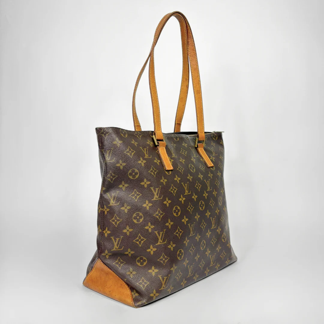 Designer handbag with monogram pattern on a white background
