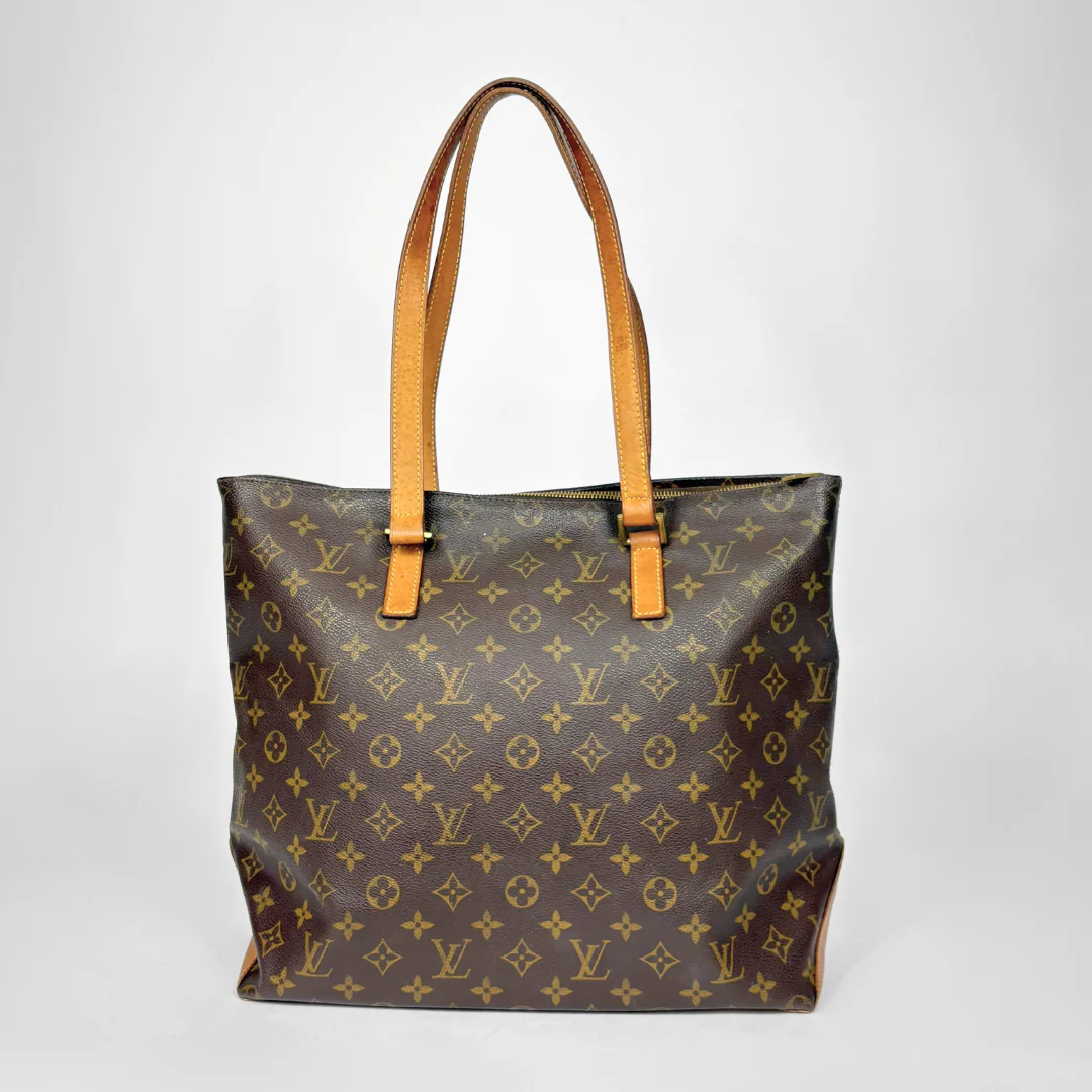 Designer handbag with monogram pattern on a white background