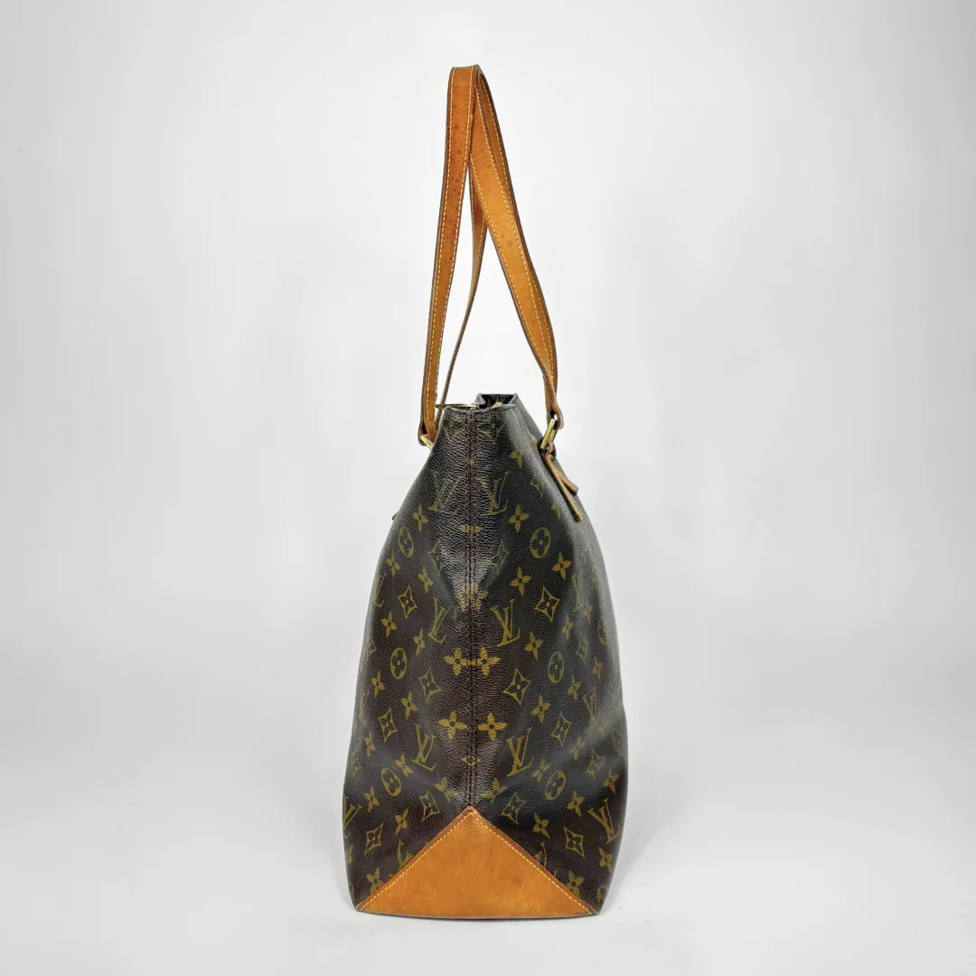 Designer handbag with monogram pattern on a white background