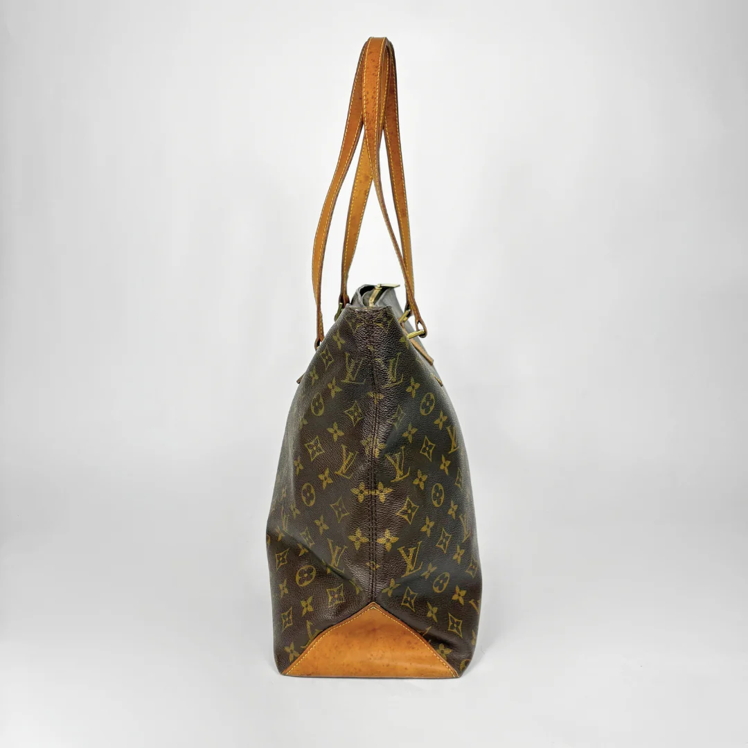 Designer handbag with monogram pattern on a white background