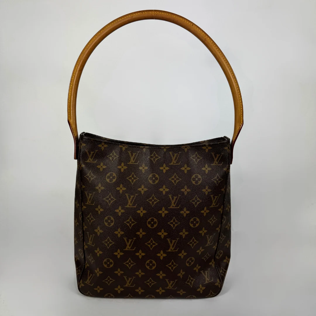A Louis Vuitton monogram canvas shoulder bag with a brown leather handle, photographed against a neutral light gray background.