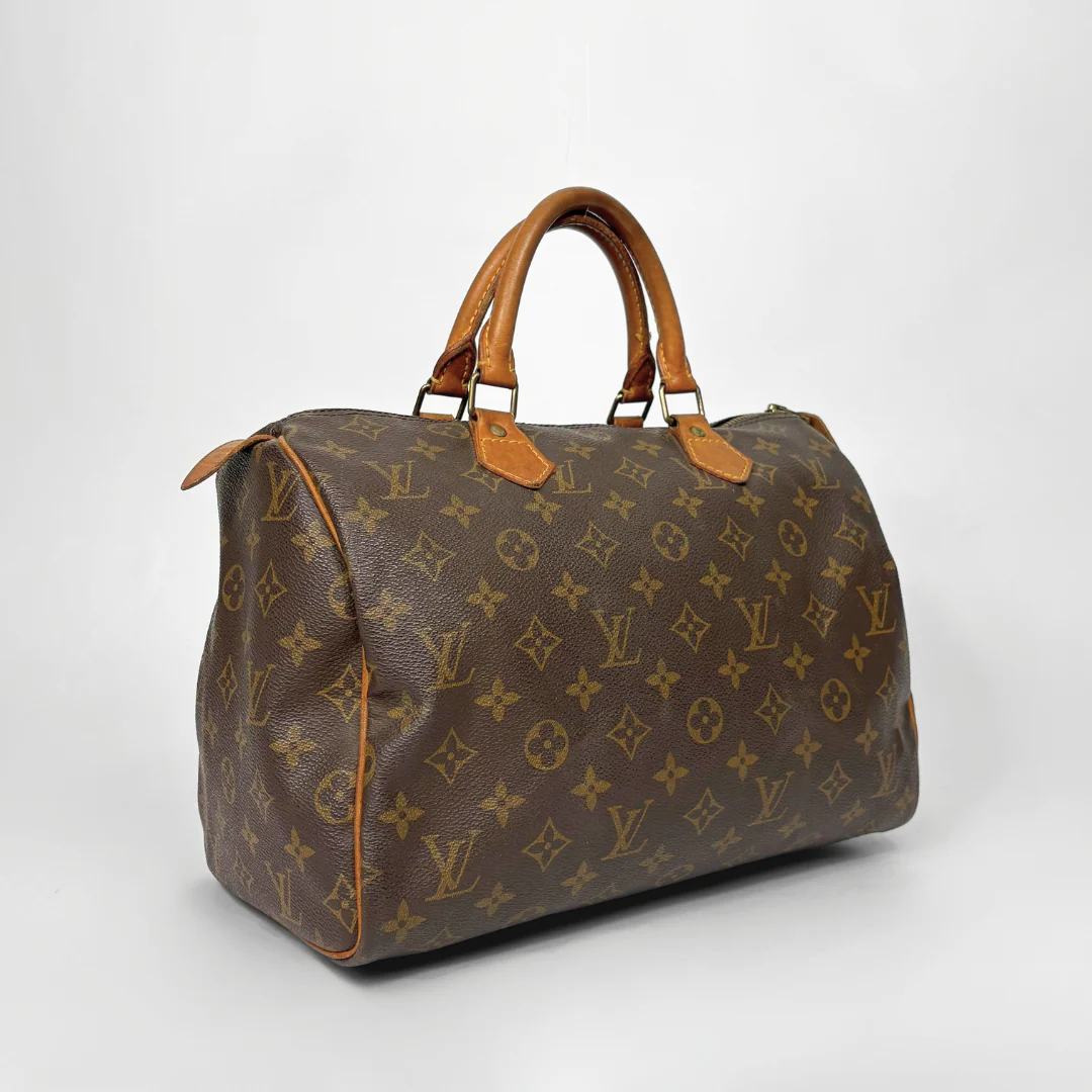 Brown Louis Vuitton handbag with monogram pattern on a white background