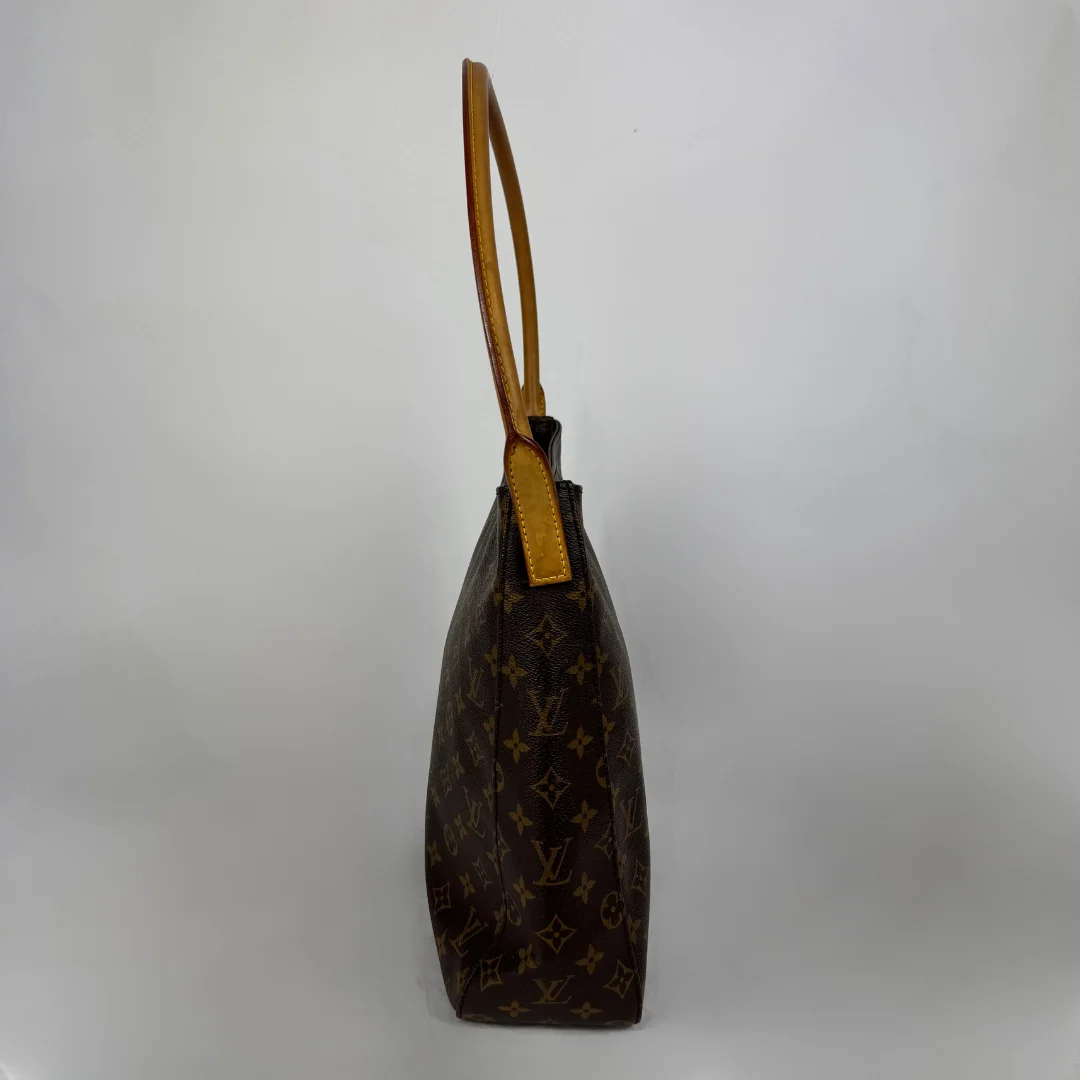 A Louis Vuitton monogram canvas shoulder bag shown from a side profile view against a plain light gray background.