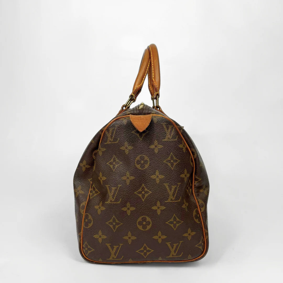 Brown Louis Vuitton handbag with monogram pattern on a white background