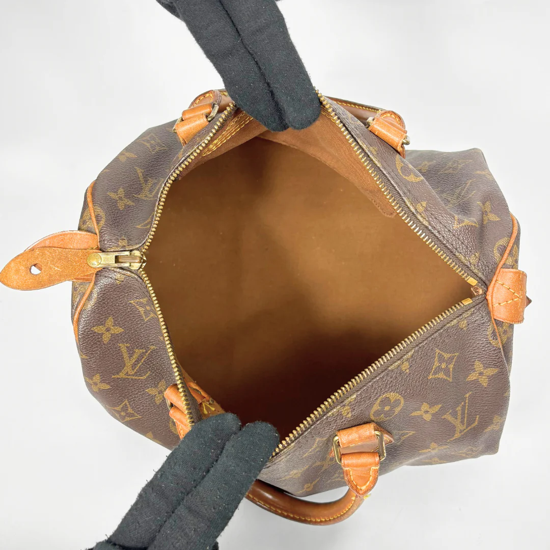 Brown Louis Vuitton handbag with monogram pattern on a white background