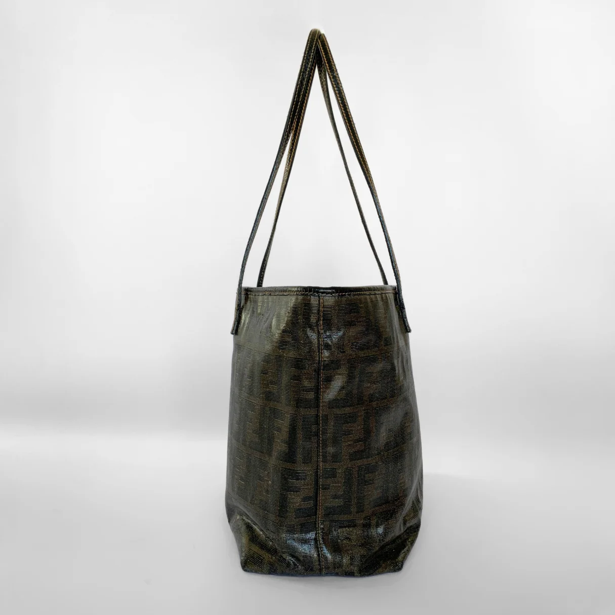Black leather handbag with a strap on a white background