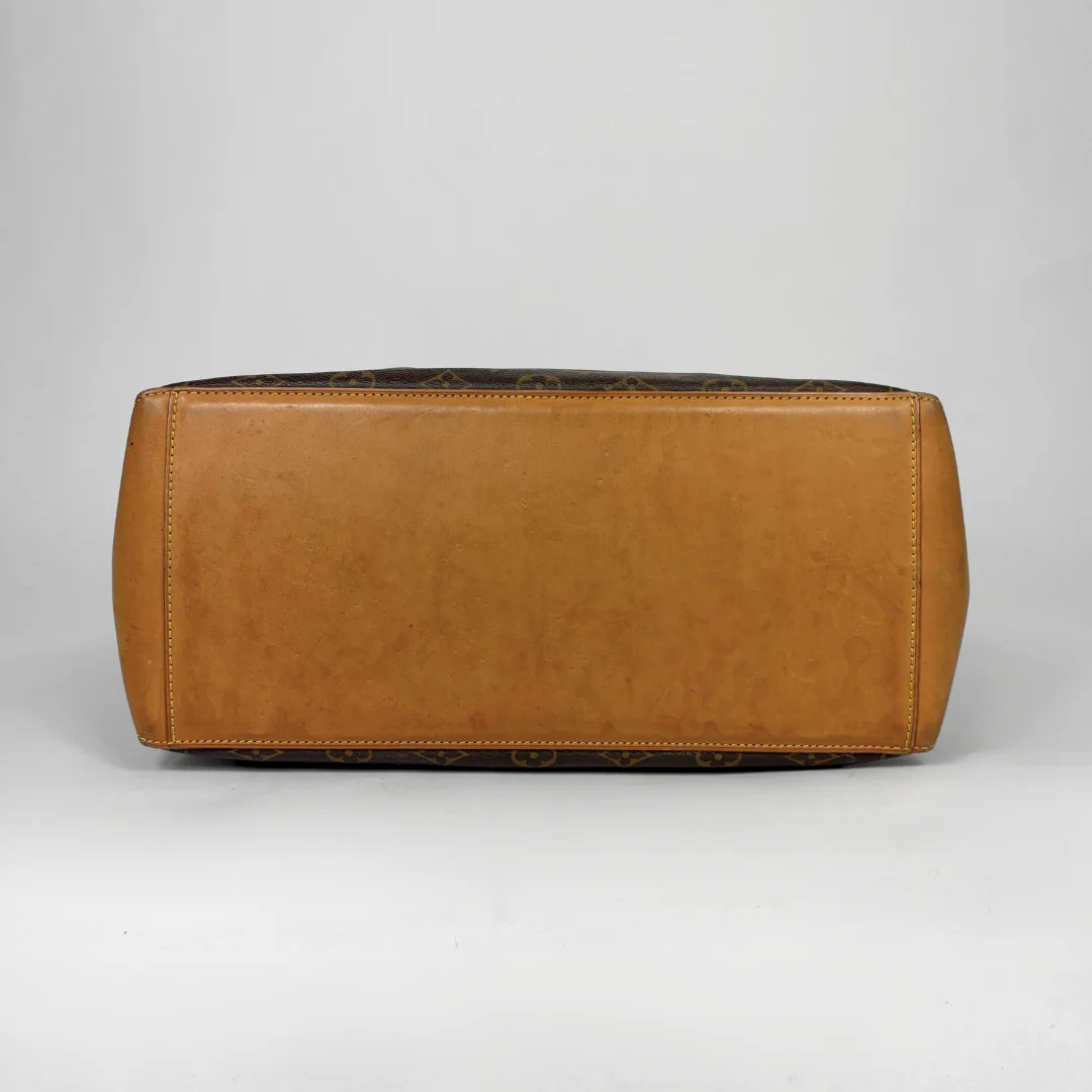 Brown leather bag on a gray background