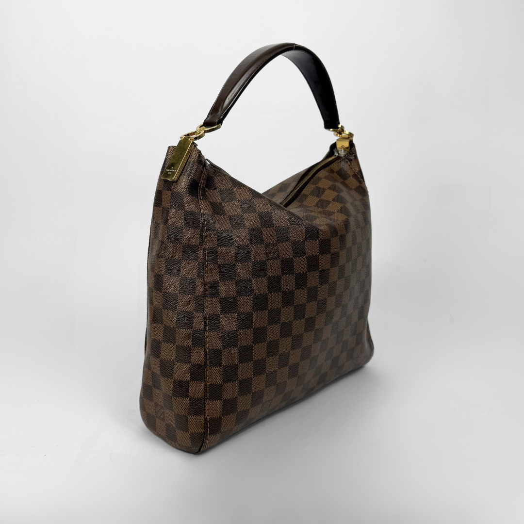 Brown checkered handbag with gold clasp on a white background
