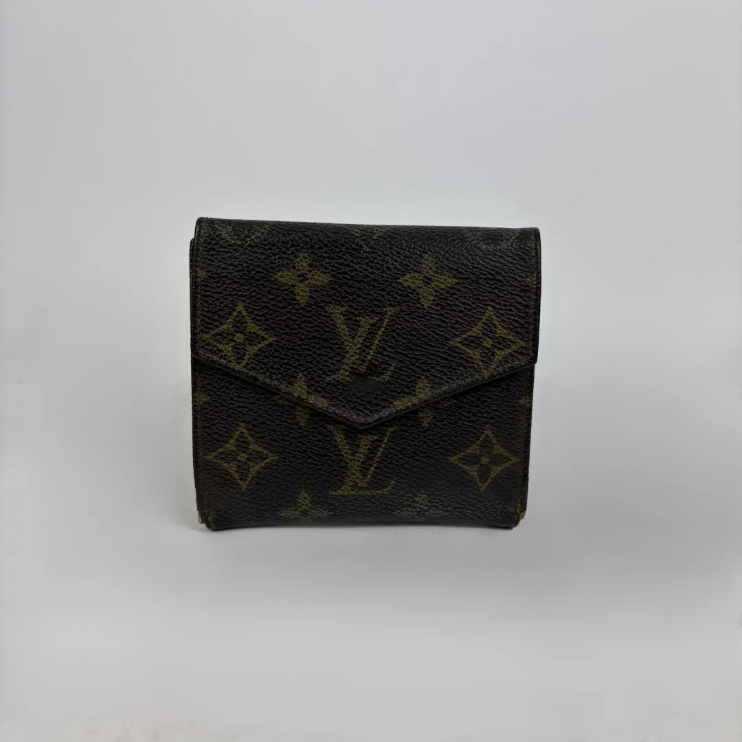 A Louis Vuitton monogram wallet in dark brown coated canvas with the classic tan/gold LV logo and floral motifs, photographed against a neutral light gray background.