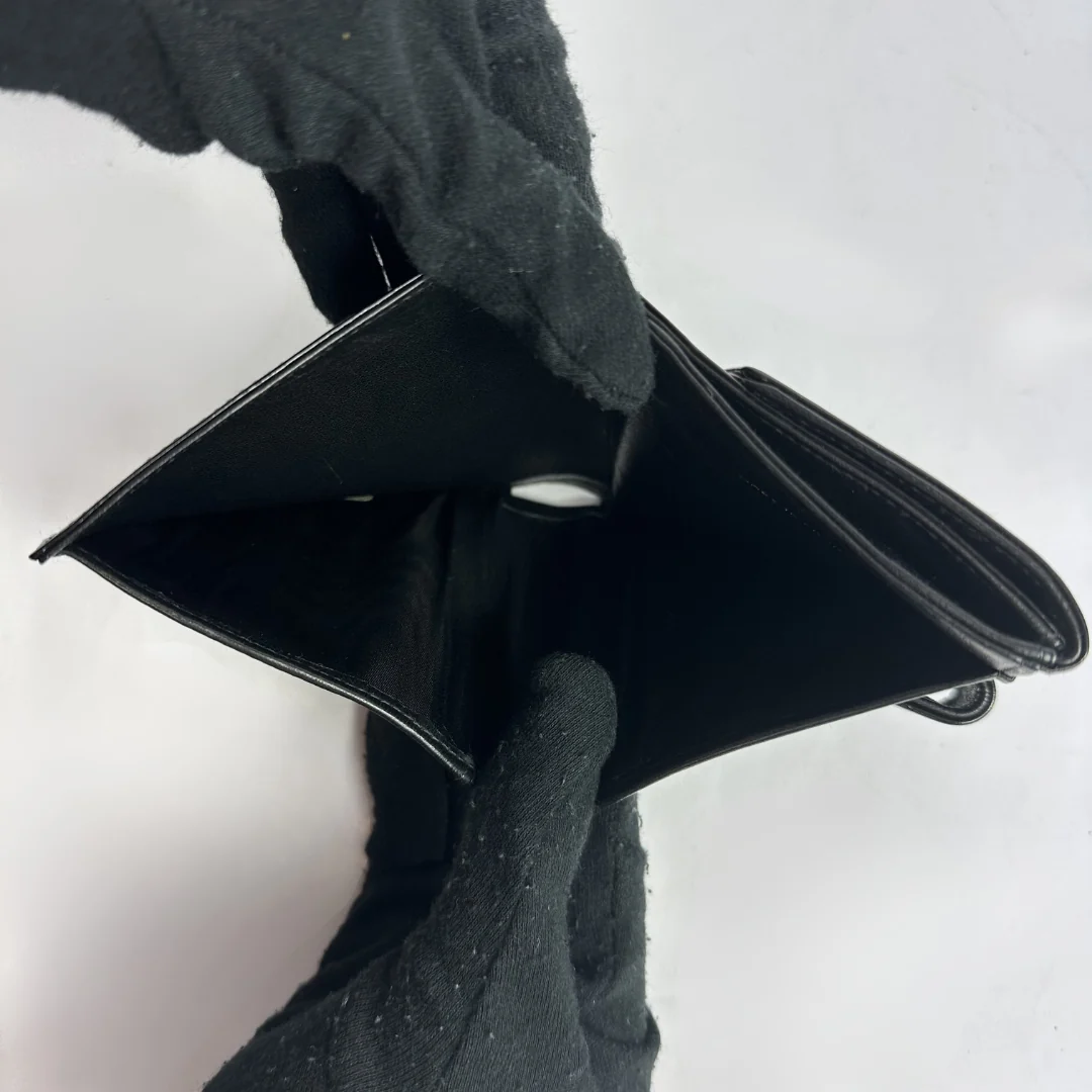 Black Chanel wallet on white background