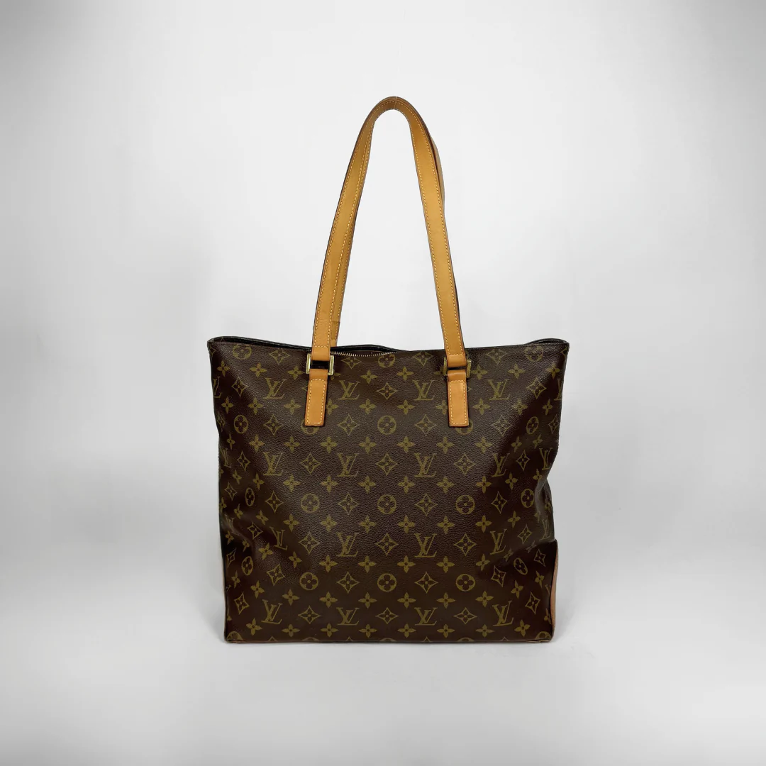 Brown patterned tote bag with tan handles on a white background