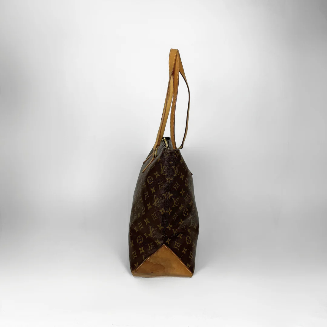 Brown handbag with monogram pattern on a white background