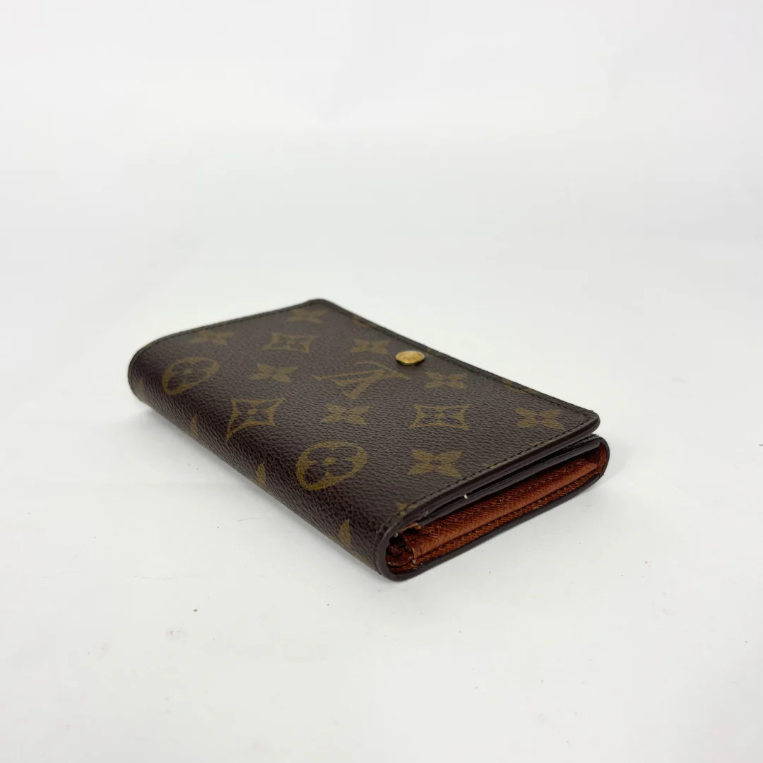 Brown wallet with monogram pattern on a white background