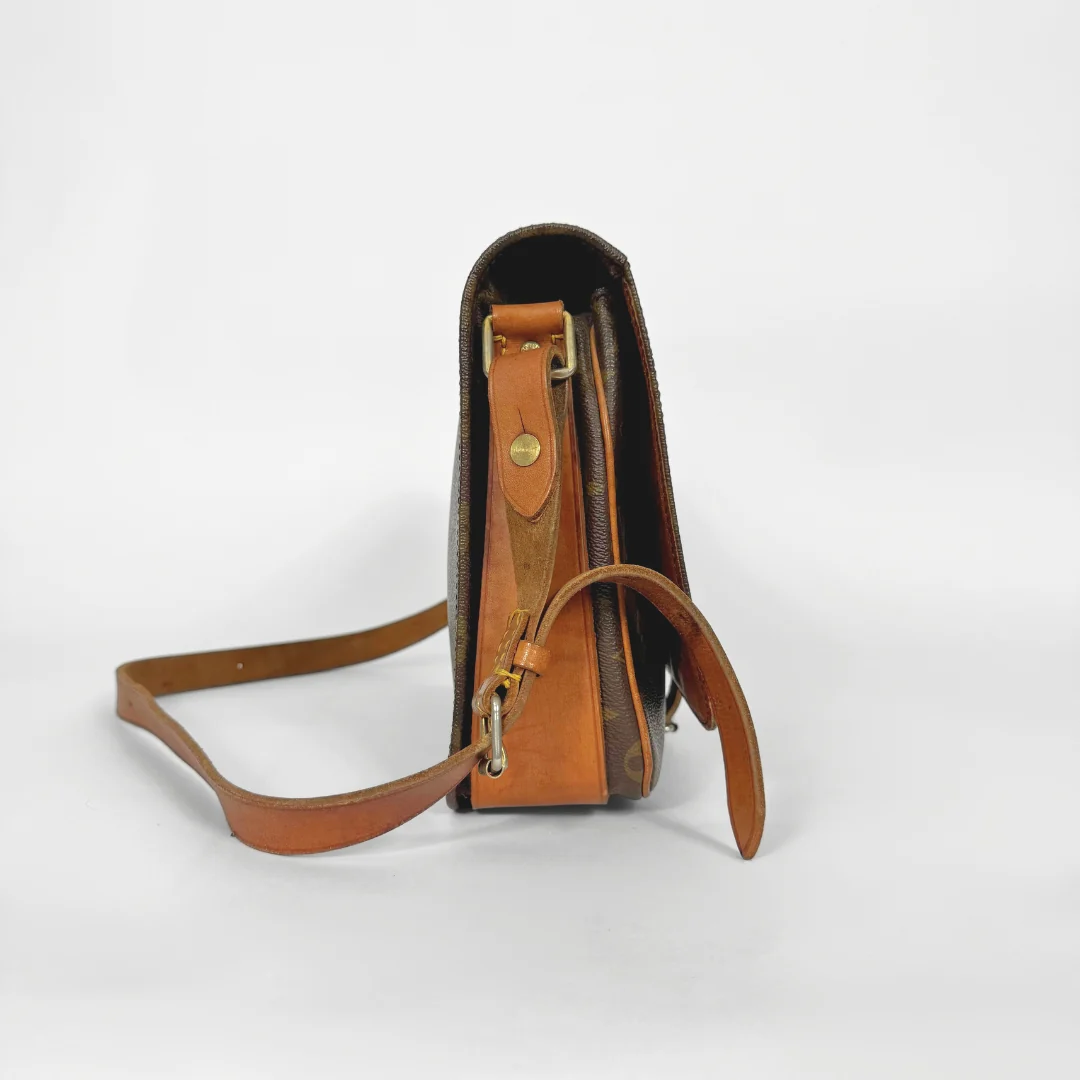 Brown leather crossbody bag on a white background