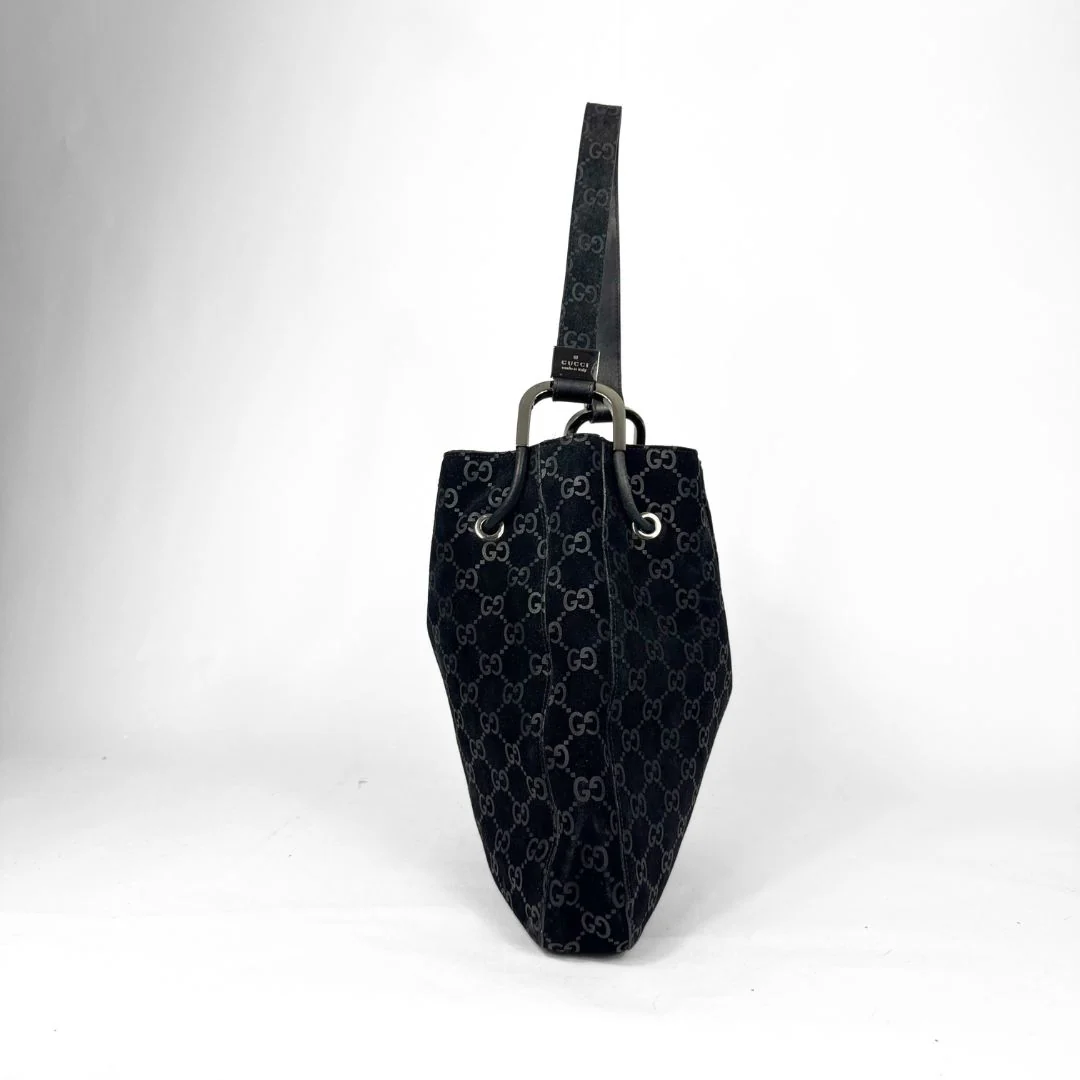 Black patterned handbag on a white background