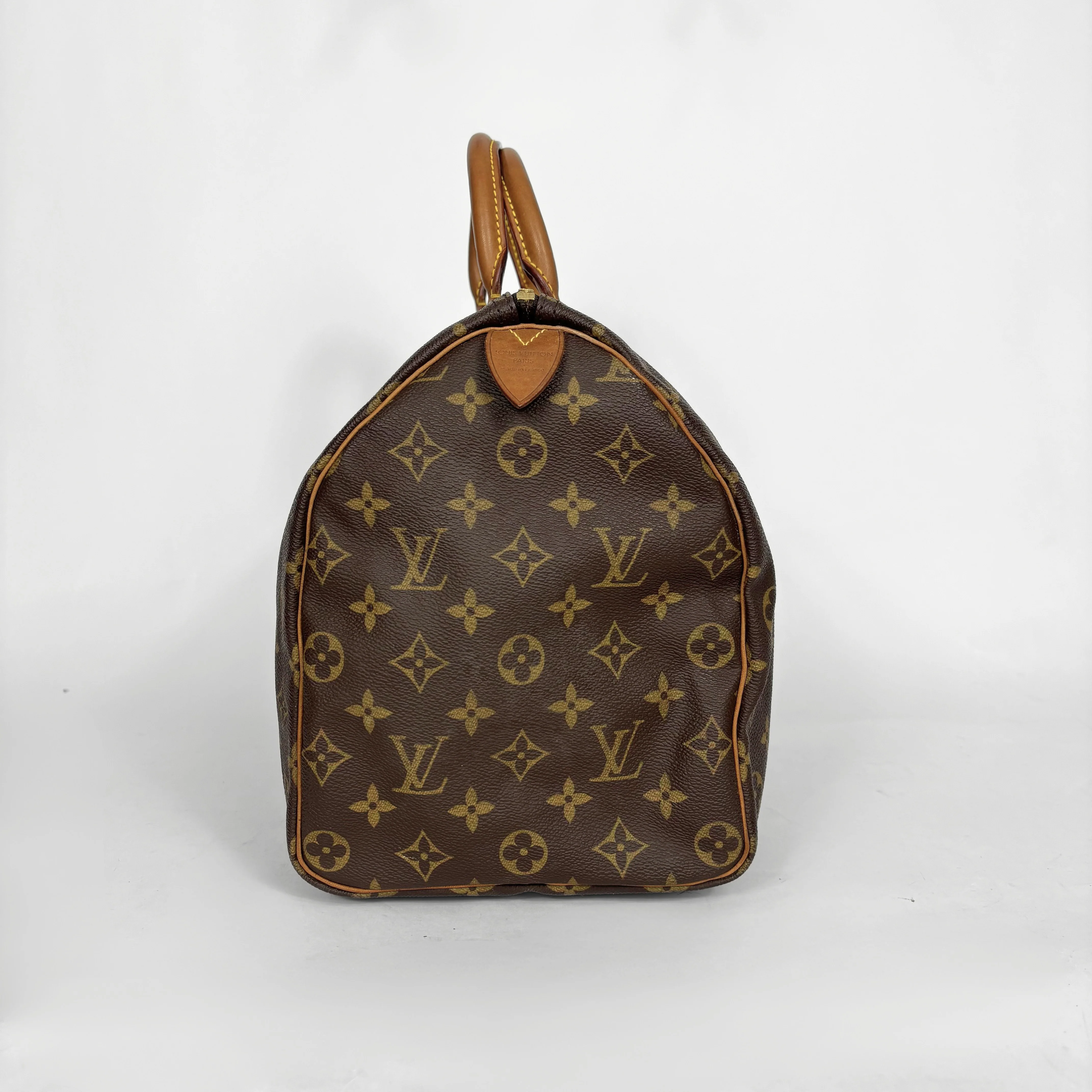 Brown handbag with a monogram pattern on a white background
