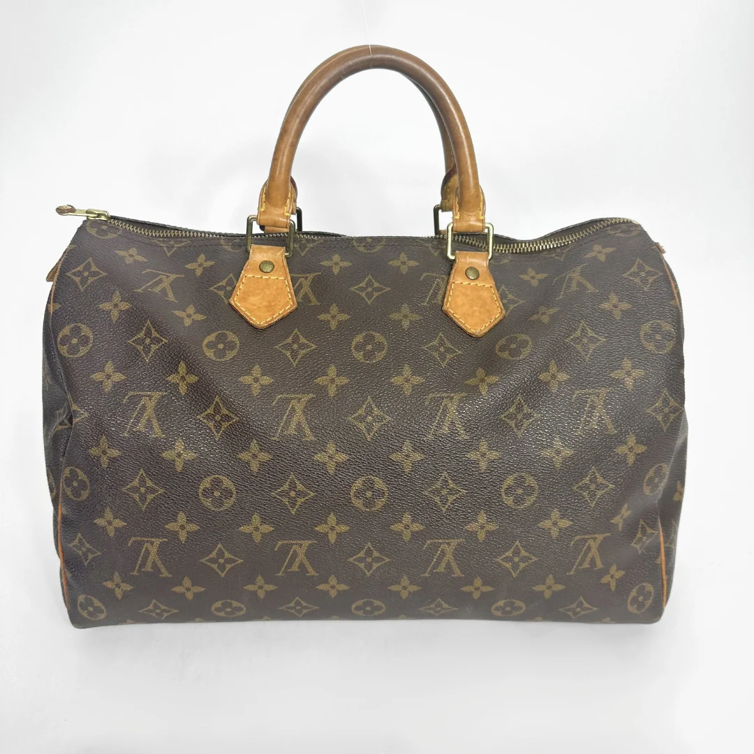 Brown handbag with a monogram pattern on a white background