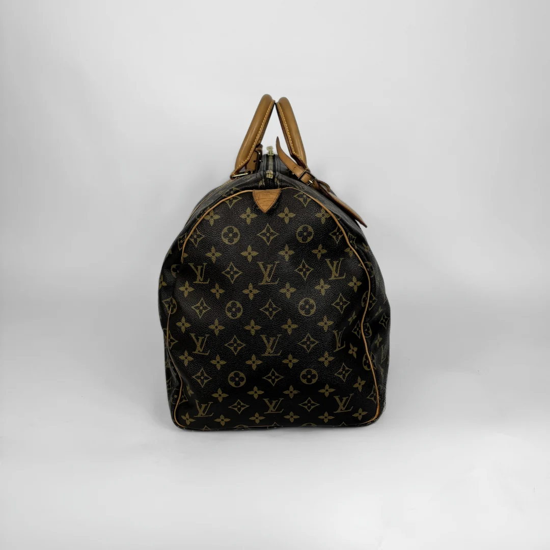 Designer handbag with monogram pattern on a white background