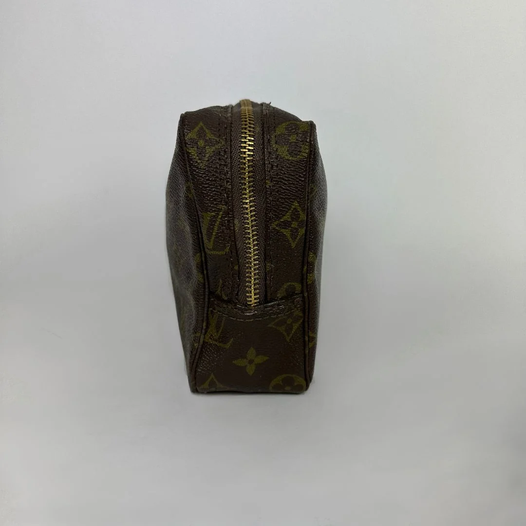 Louis Vuitton toiletry bag in front of white background
