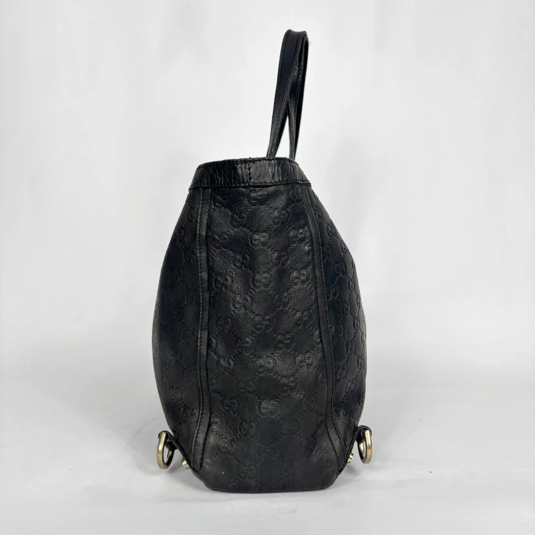Black Gucci handbag on a white background
