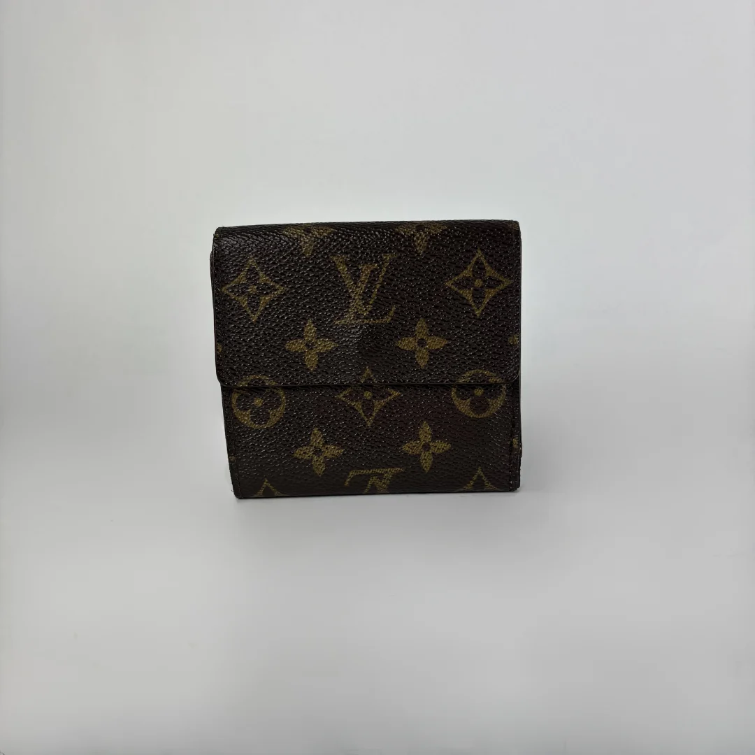 A Louis Vuitton monogram wallet in dark brown coated canvas with tan/gold printed monogram motifs, shown against a plain light gray background.