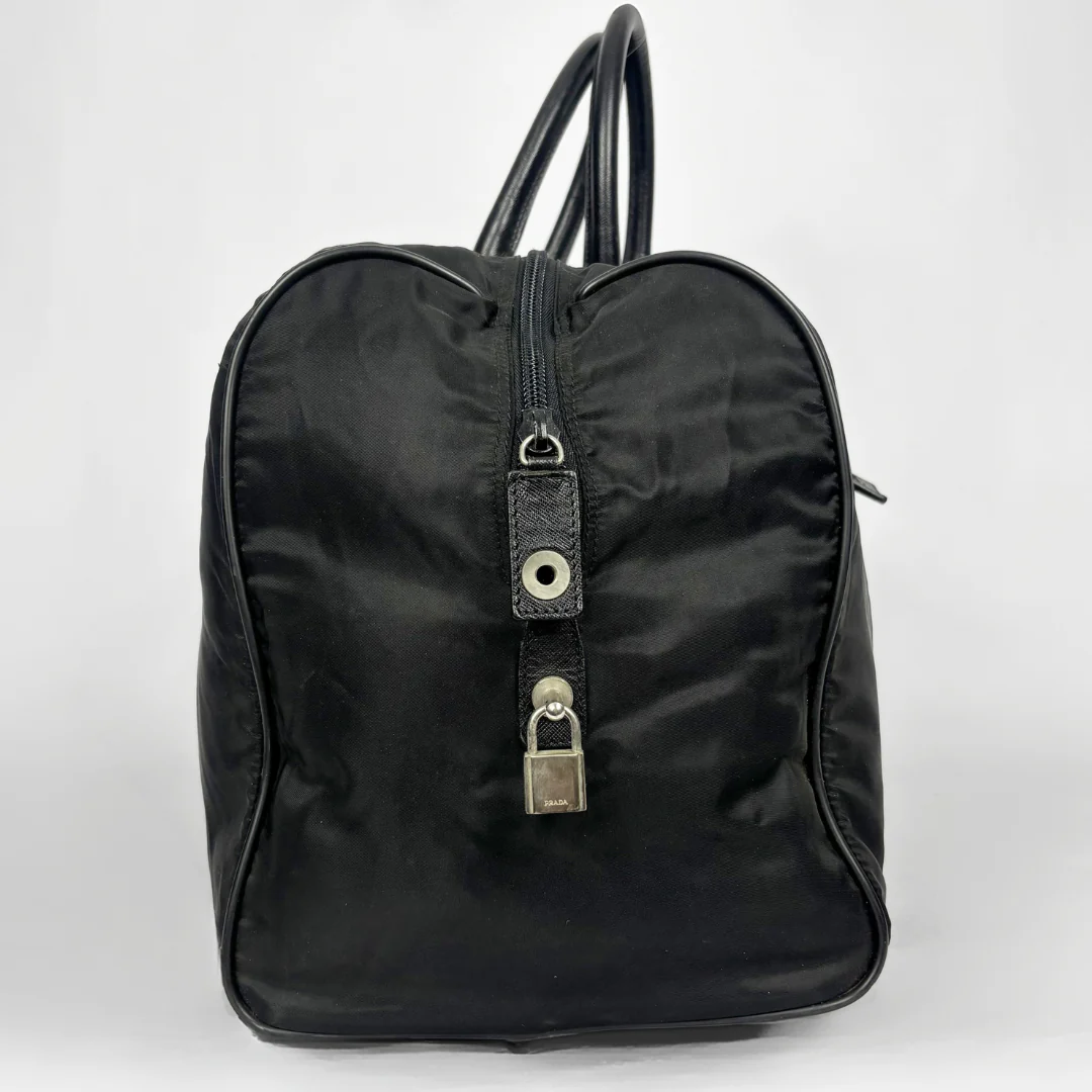Black backpack with a strap and lock on a white background