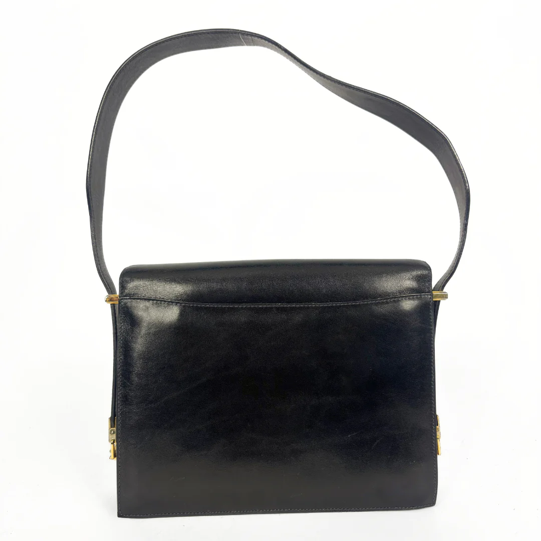 Celine vintage black leather shoulder bag with gold-tone horse and cariage buckle.