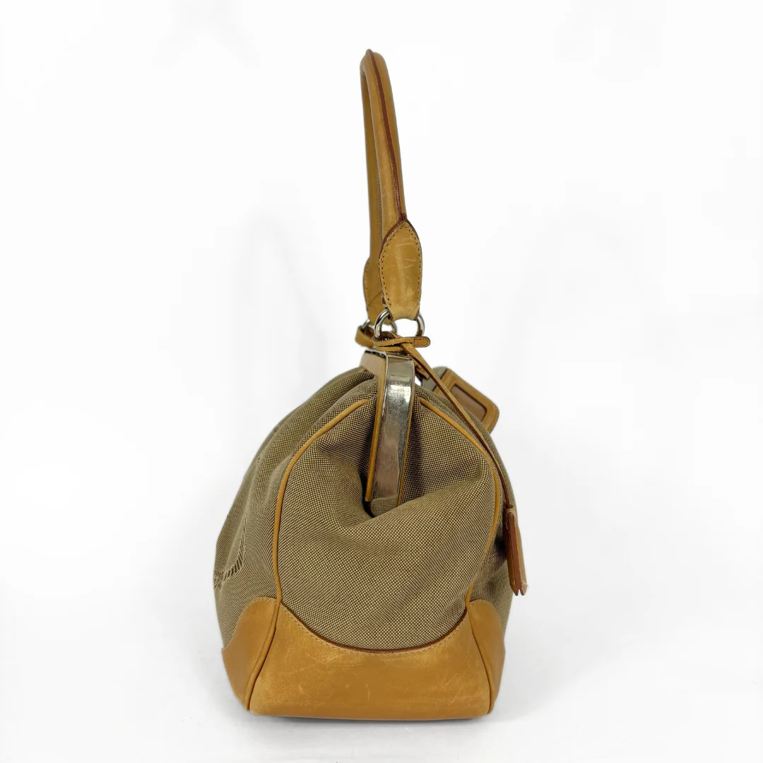 Brown handbag with gold accents on a white background