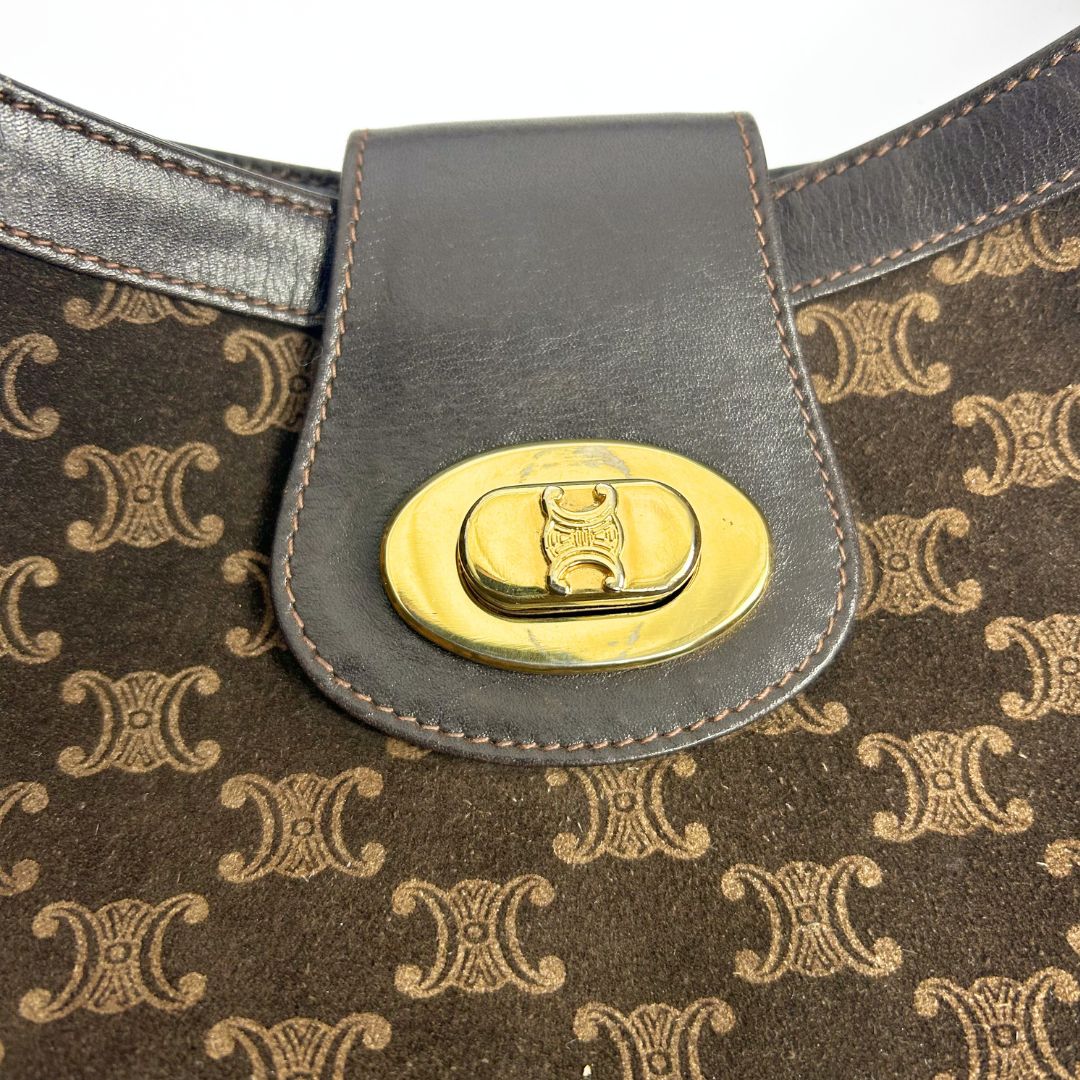 Brown patterned bag with a gold buckle on a white background