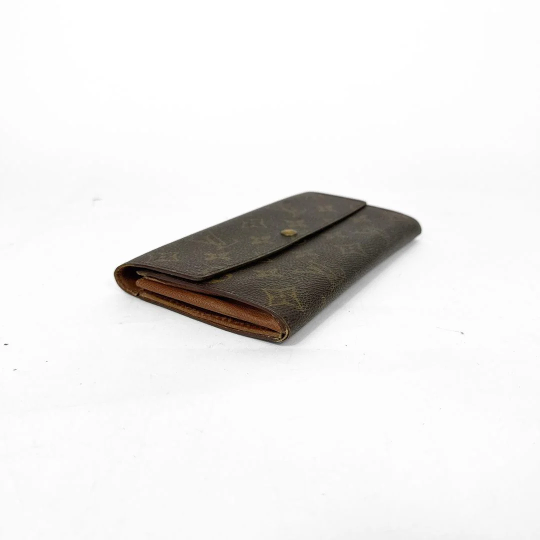 Brown wallet with visible brand logo on a white background