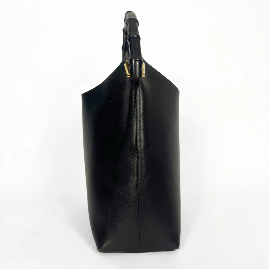 Gucci vintage black leather hobo hag with a dark wood bamboo top handle and gold-tone hardware.