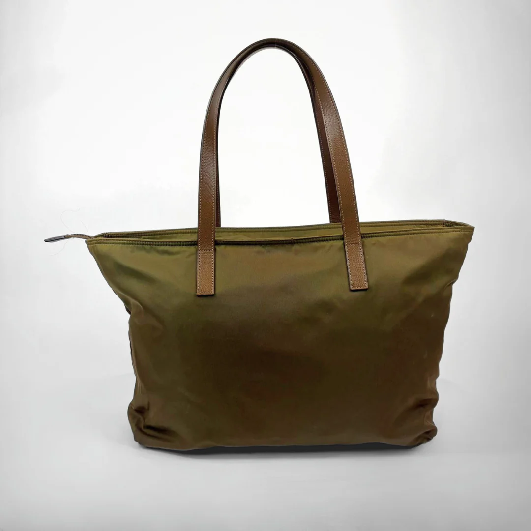 Green tote bag with brown handles on a white background