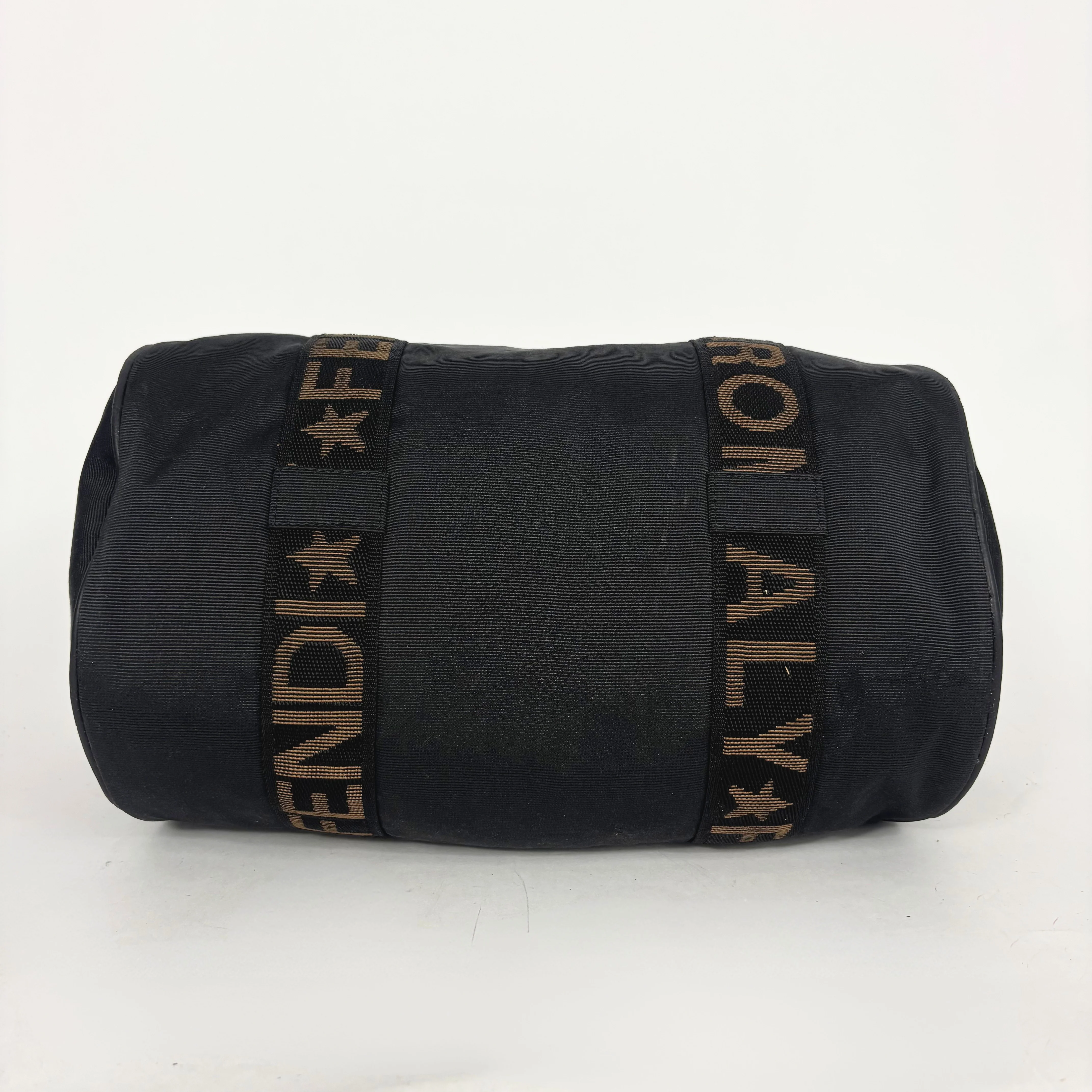 Black duffel bag with 'FENDI' logo on a white background