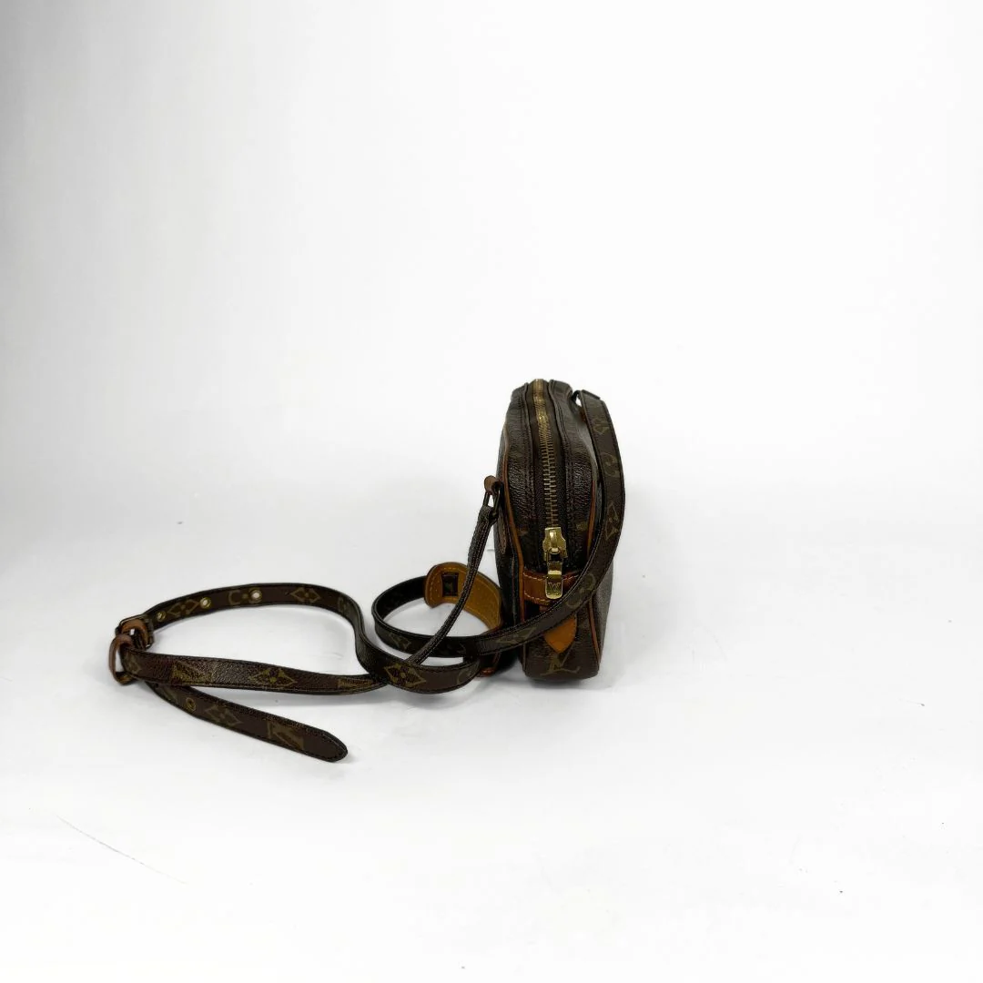 Vintage leather crossbody bag with a strap on a white background
