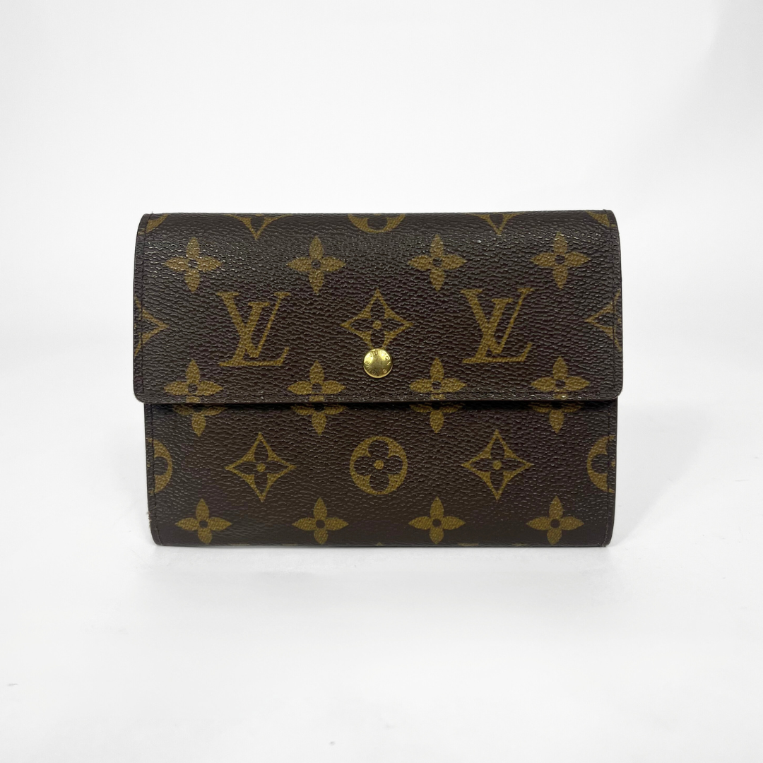 Louis Vuitton wallet with monogram pattern on a white background