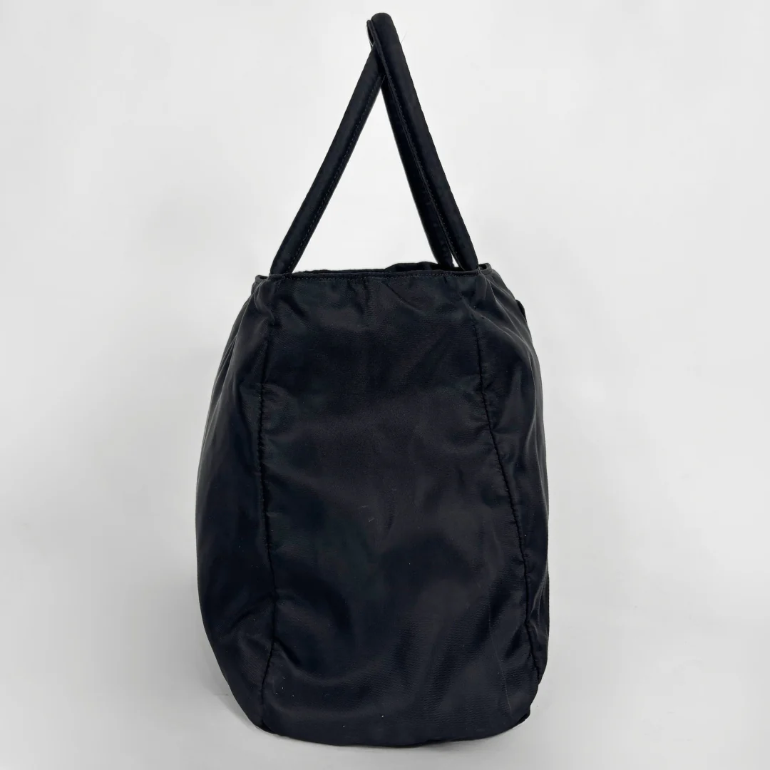 Prada black nylon tote bag with top handles and the classic enamel triangle logo.