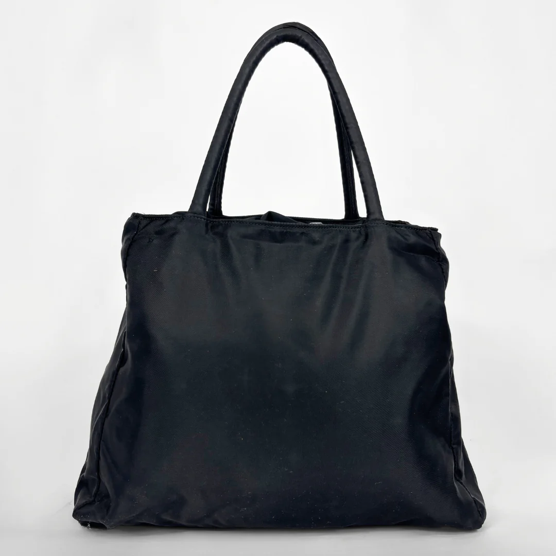 Prada black nylon tote bag with top handles and the classic enamel triangle logo.